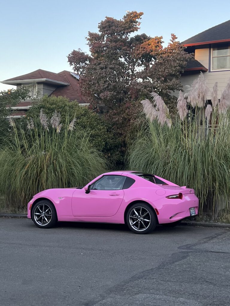 Green car named matcha parked on the side of the street